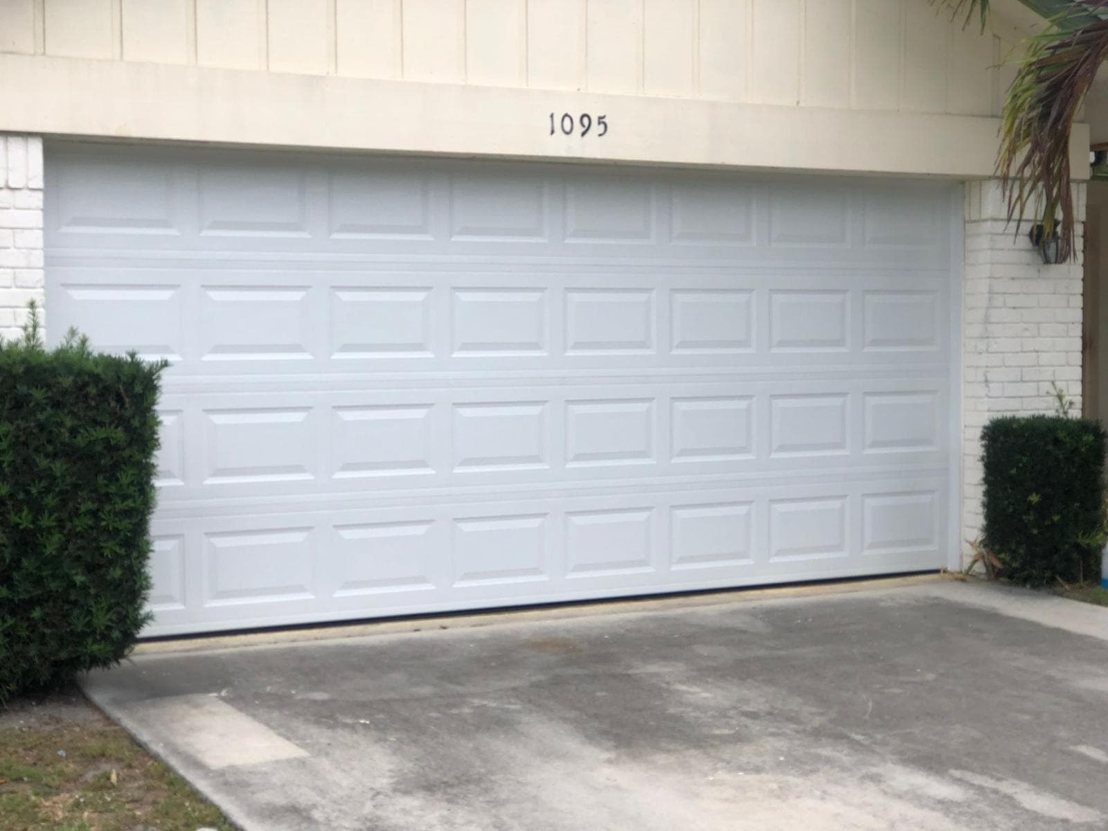 Garage door repair and hardware service on a South Florida home — springs, tracks, and rollers by 305 Doors Corp